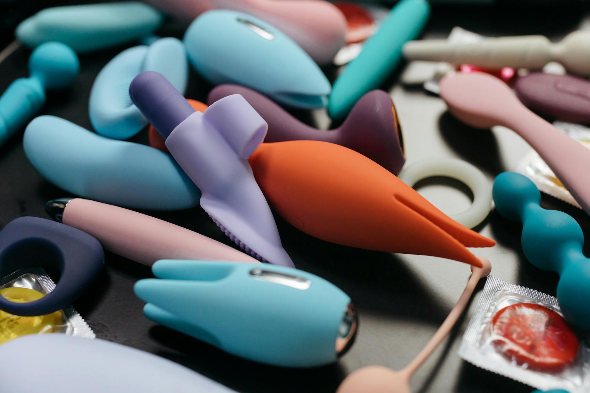 An array of vibrant adult toys including lemon vibrators and massage devices in close-up view.