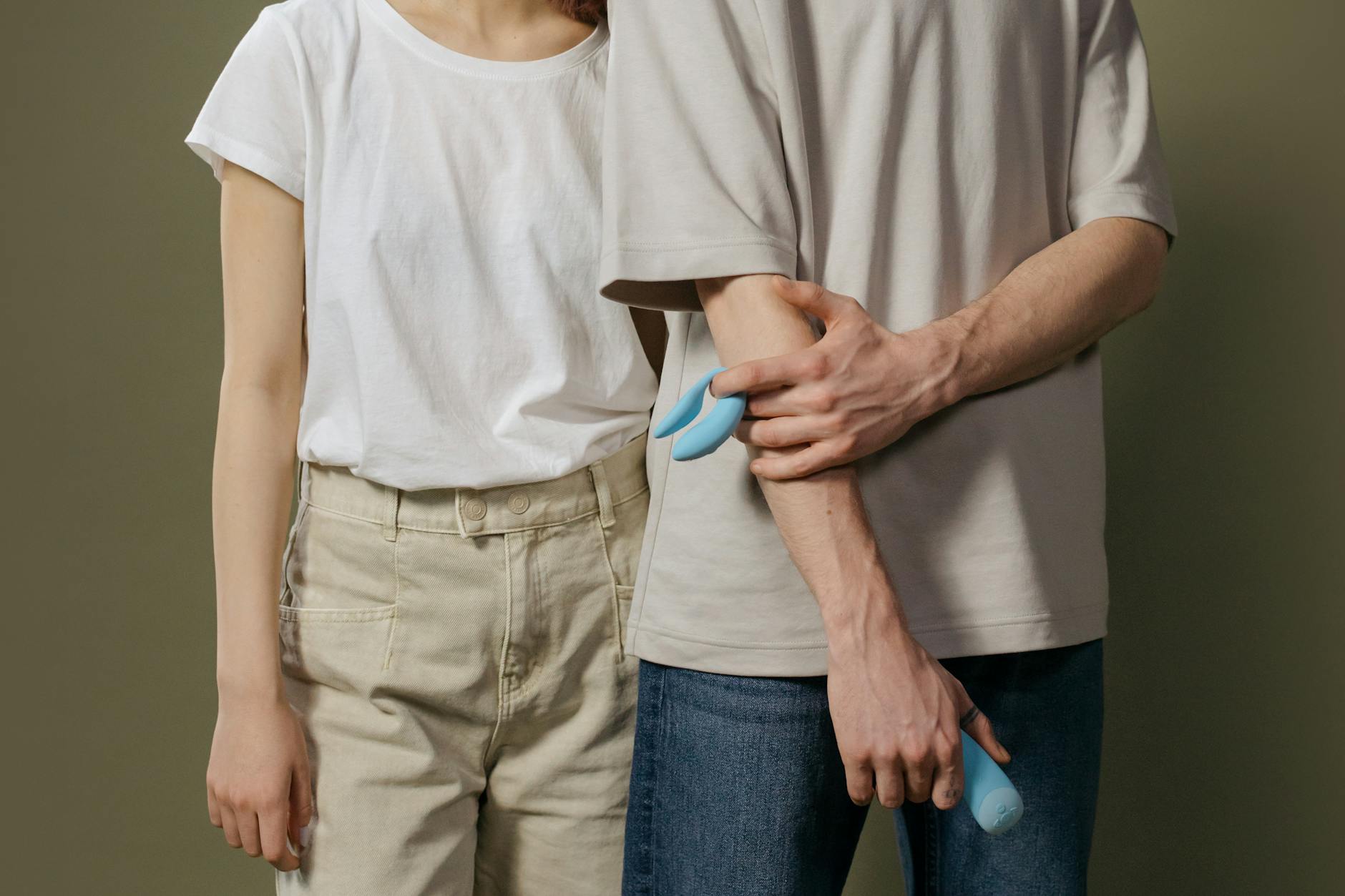A couple holding a vibrator together, symbolizing shared intimacy and communication